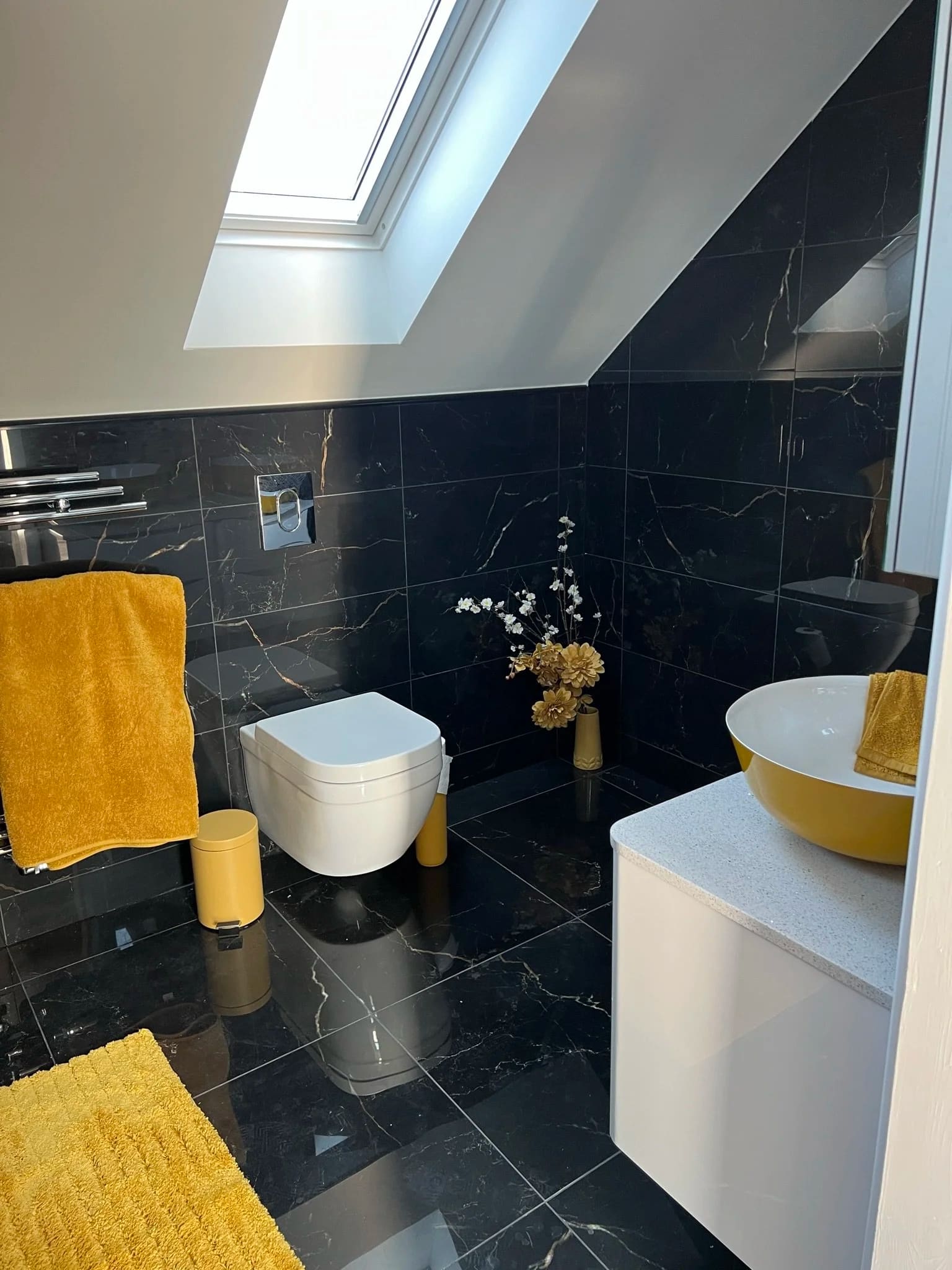 Black marble bathroom with brass-coloured veining, fitted by NHF in Grays